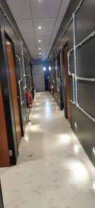 a hallway with doors and a long aisle at The Village Inn in Raub