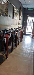a row of tables and chairs in a restaurant at The Village Inn in Raub