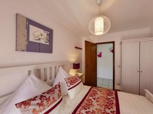 a bedroom with a bed with red and white pillows at Uitzicht op het meer - formerly TUI in Schalkenmehren