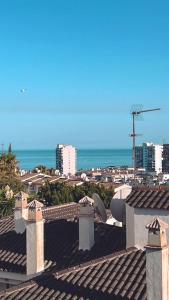 a view of the ocean from the roof of a building at Pueblo Evita. Stunning sea and mountain views, close to amneties. in Benalmádena