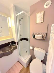 a bathroom with a shower and a toilet and a sink at Cap Esterel, Duplex ,Vue Mer Climatisé in Agay - Saint Raphael +9 photos