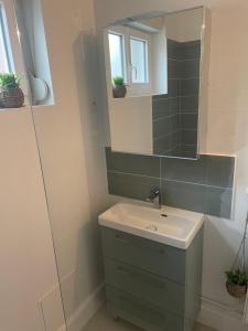 a bathroom with a sink and a mirror at Appartement calais nord in Calais