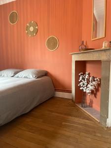 a bedroom with a bed and a fire place at Appartement calais nord in Calais