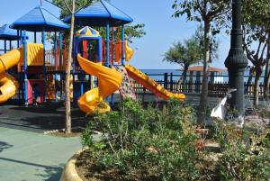 a playground with a slide in a park at Sabinillas Apartment in San Luis de Sabinillas