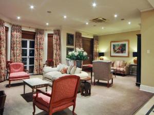 a living room with a couch and chairs at Redlands Hotel in Pietermaritzburg