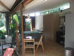a room with a bed and a table and chairs at Springfield Studio in Auckland