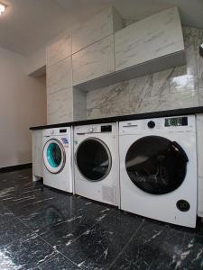 two washing machines sitting next to each other in a kitchen at Villa Scandinavia in Mostar