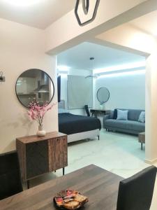a living room with a bed and a mirror at BlackGeorge Apartment in Ioannina