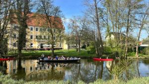 a group of people in a boat on a river at Waldhaus am See in Neu Zauche +18 photos