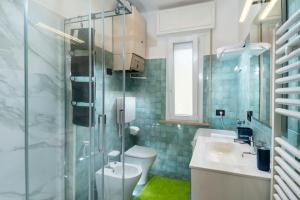 a bathroom with a toilet and a sink and a shower at Magnani Appartamenti in Misano Adriatico