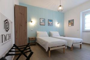 Postel nebo postele na pokoji v ubytování DOMINA Guest House