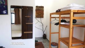 a room with a bunk bed and a mirror at Người Măng Đen Homestay in Kon Von Kla