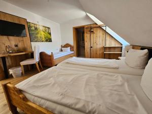 a bedroom with two large beds and a staircase at Hotel & Restaurant Tanne in Fischingen