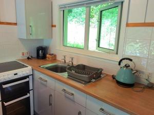 a kitchen counter with a sink and a stove at Kiberick Cottage at Crackington Haven, near Bude and Boscastle, Cornwall in Bude +18 photos