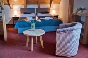 Postel nebo postele na pokoji v ubytování Hotel U Lípy