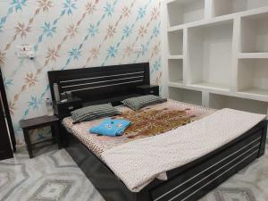 a bedroom with a bed in a room at Awadh Royals Homestay Ayodhya in Ayodhya +11 photos