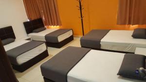 Ένα ή περισσότερα κρεβάτια σε δωμάτιο στο PKA Homestay - Sewa Bilik