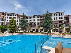 a large swimming pool in front of a building at Mountain Breeze Villa in Rogachevo