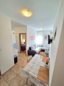 a living room with a table and a couch at Apartments Vjeko in Split