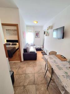 a living room with a couch and a table in a room at Apartments Vjeko in Split