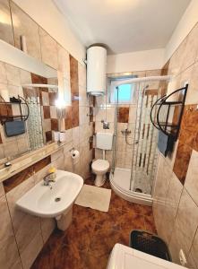 a bathroom with a sink and a shower and a toilet at Apartments Vjeko in Split +25 photos