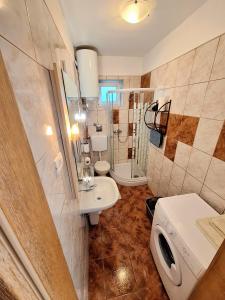 a bathroom with a toilet and a sink and a shower at Apartments Vjeko in Split