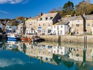 a harbor with boats in the water next to houses at Bantry Cottage at Crackington Haven, near Bude and Boscastle, Cornwall in Bude