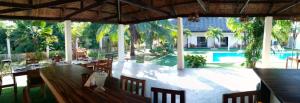 a restaurant with a table and chairs and a pool at HIGALA Resort in Panglao Island