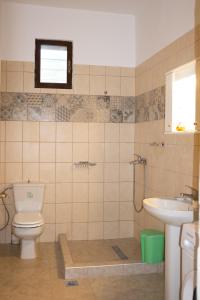 a bathroom with a toilet and a sink at Doctors' House Mikros Prinos in Mikrós Prínos +31 photos
