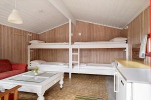 a room with three bunk beds and a table at Utladalen Camping in Årdal