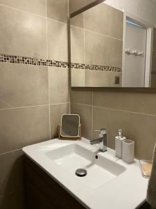 a bathroom with a white sink and a mirror at Corse Calvi appt coté Mer in Calvi +56 photos