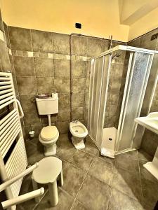 a bathroom with a toilet and a shower at Palazzo Marzano in Briatico