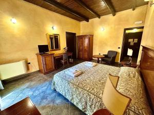 a hotel room with a bed and a desk at Palazzo Marzano in Briatico +78 photos