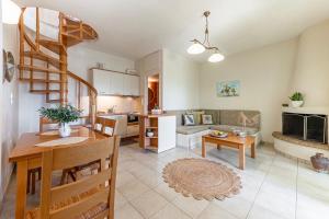 a kitchen and a living room with a spiral staircase at Terra Calma Residence 2 in Karistos