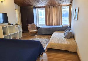 a hotel room with two beds and a television at Bhurban Valley Cottages 3 in Bhurban
