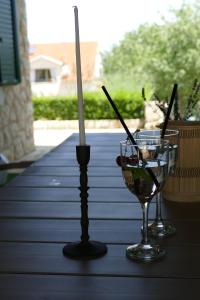 una candela e un bicchiere di vino su un tavolo di Kalpic Suites & Villa a Lozovac