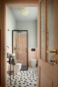 a bathroom with a tub and a toilet and a sink at Zelda in Udine +45 photos