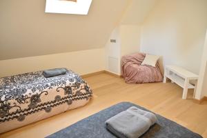 a room with a bed and a table and a desk at Nature Nest in Pontivy