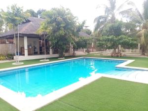 a swimming pool in front of a villa at HIGALA Resort in Panglao Island
