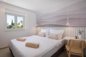 a bedroom with a large white bed and a window at Villa Porto in Ražanj +125 photos