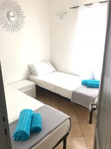 a small room with two beds and a window at International House San Teodoro in San Teodoro +19 photos