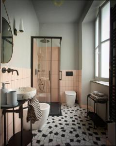 a bathroom with a shower and a sink and a toilet at Zelda in Udine