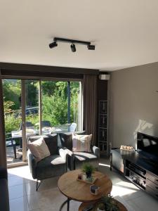 a living room with a couch and a table at Durbuy Dream in Durbuy