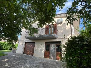 a large white house with a balcony and a garage at Casa Vacanze La Noce in Roseto Valfortore