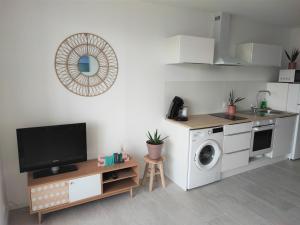 a kitchen with a washing machine and a microwave at Appartement T2 neuf vue mer en bord de mer in Six-Fours-les-Plages