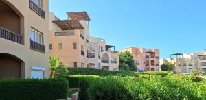 a row of apartment buildings with bushes and trees at El Gouna Waterside E 1-Bedroom Ground Floor Sleeps 4 Persons in Hurghada