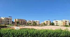 a park in front of some apartment buildings at El Gouna Waterside E 1-Bedroom Ground Floor Sleeps 4 Persons in Hurghada +18 photos