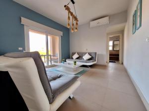 a living room with a couch and a table at El Gouna Waterside E 1-Bedroom Ground Floor Sleeps 4 Persons in Hurghada