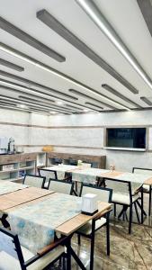 a dining room with tables and chairs in a room at Toprak City Hotel Antalya in Antalya