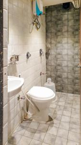a bathroom with a toilet and a sink at Hotel Nova Star in Rajkot
